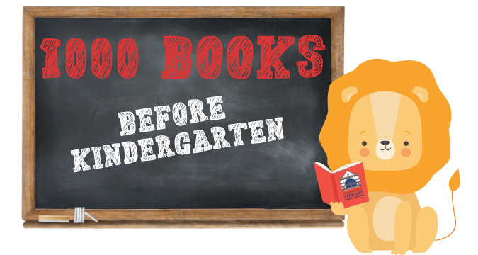 chalkboard with a cartoon lion standing beside it with a book